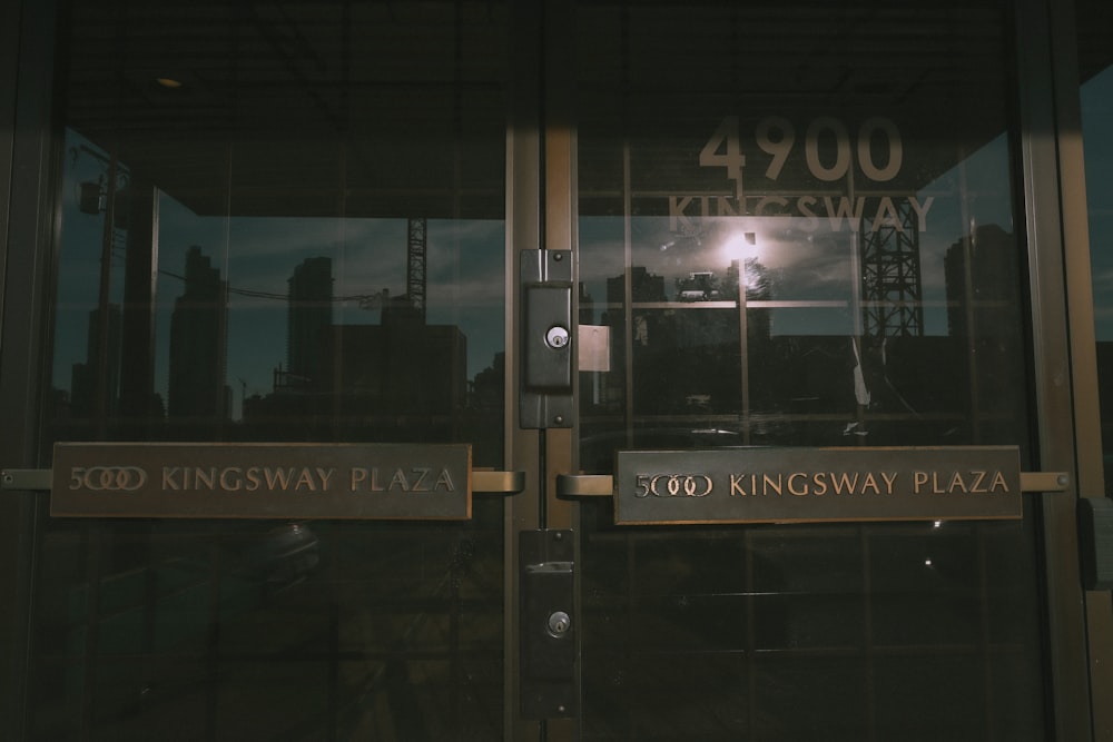a glass door with a sign that says kingsway plaza