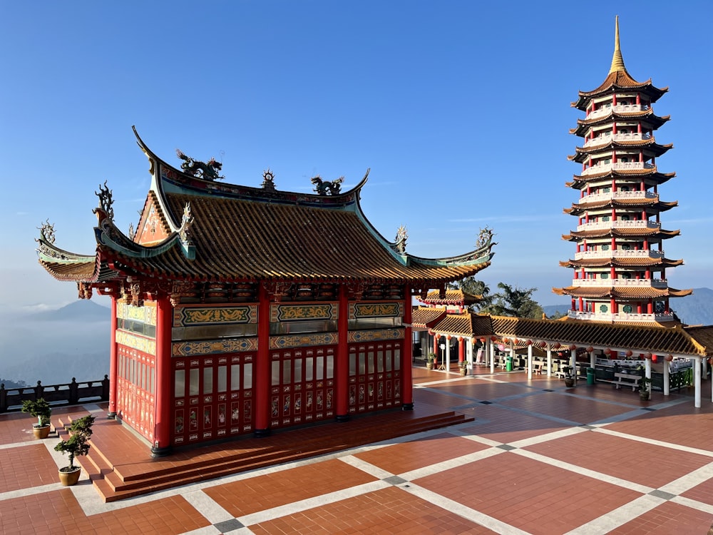 a tall red building sitting next to a tall tower