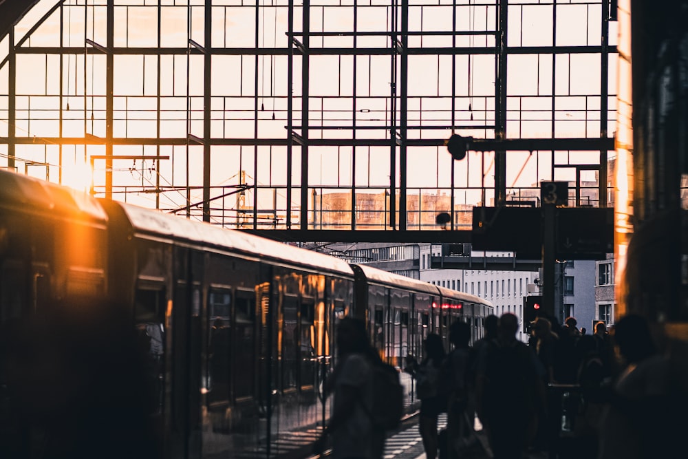 a group of people walking next to a train