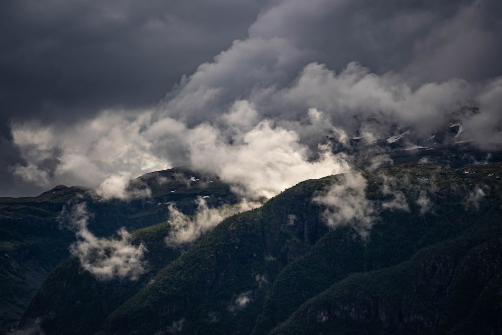 a view of a mountain range covered in clouds