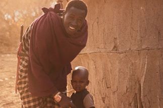 A warm, inviting photo of a traveler chatting with a local guide against the backdrop of the Atlas Mountains.