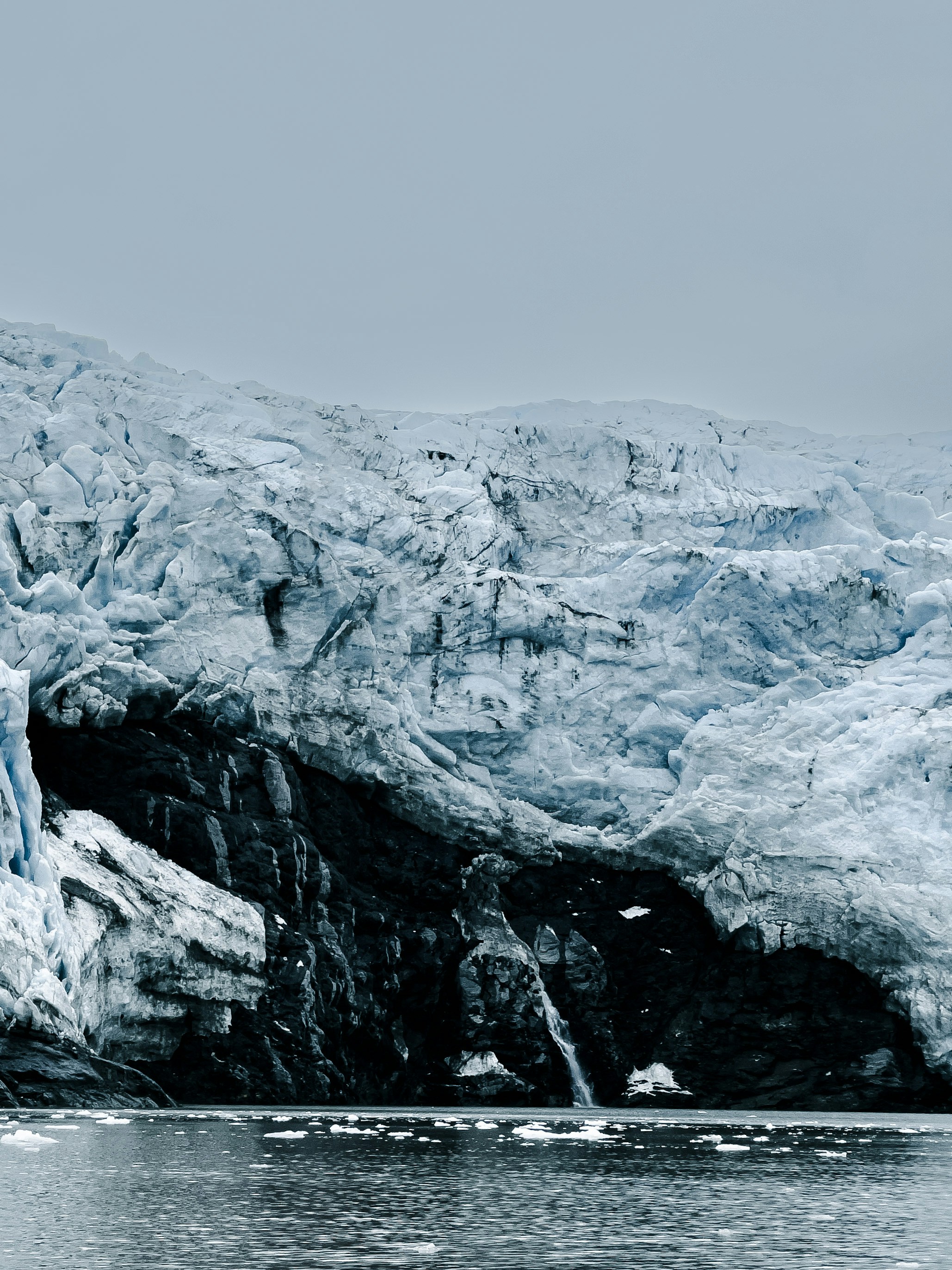 a large glacier with a mountain in the background