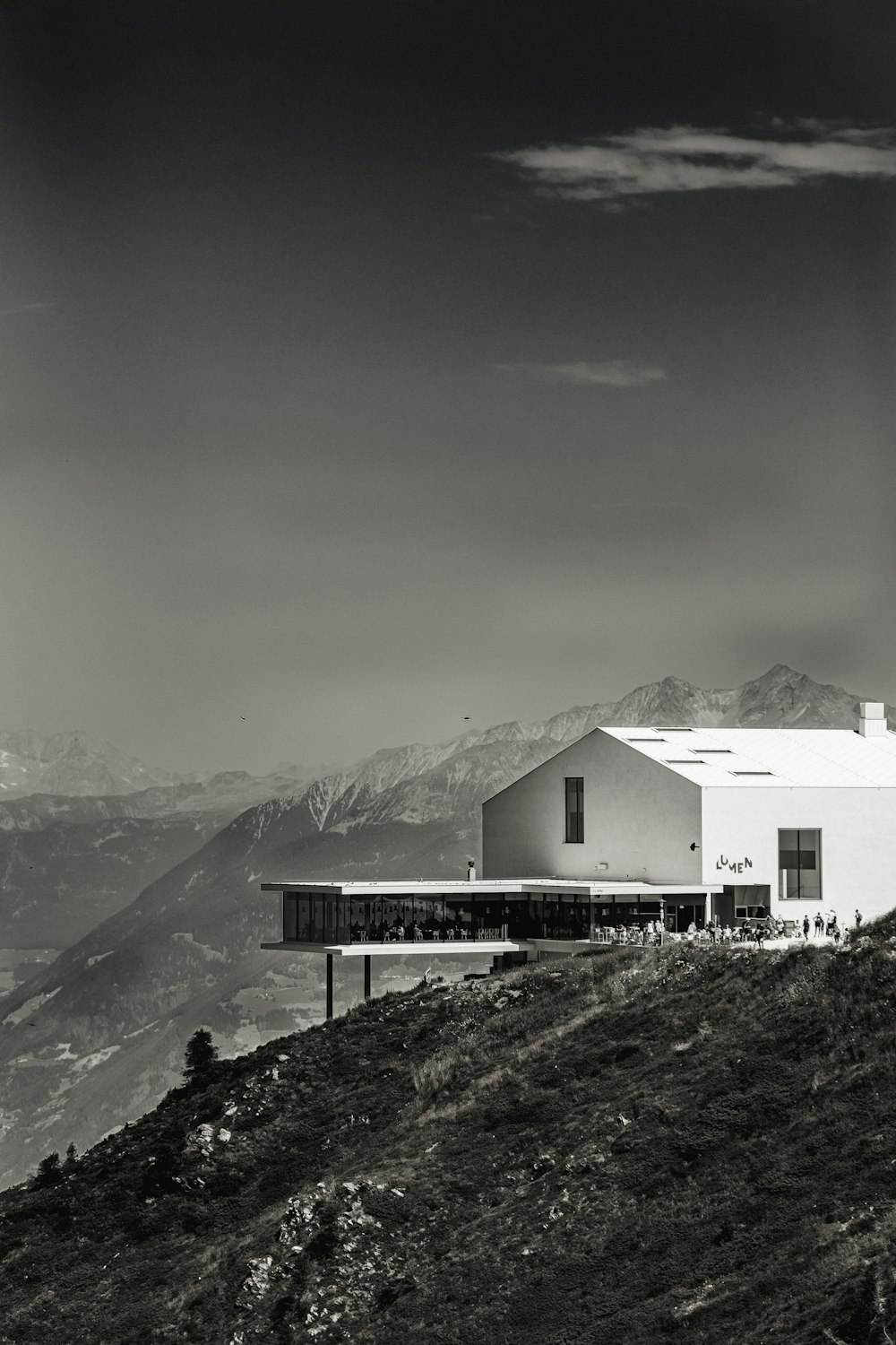 a black and white photo of a building on a hill