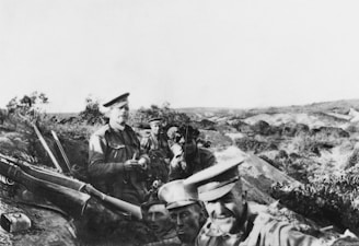 a black and white photo of a group of men with guns
