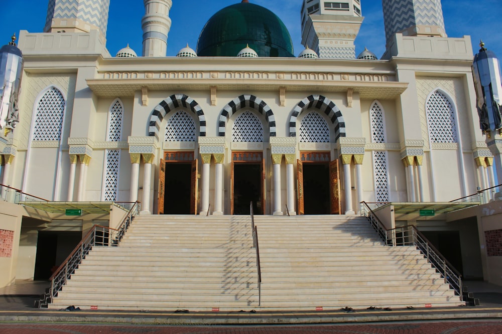 a large white building with a green dome