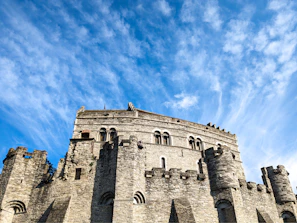 Historic Castelnaud la Chapelle castle perched on a hilltop against a clear blue sky