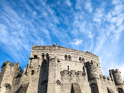 Historic Auckland Castle with its grand stone facade under a bright blue sky