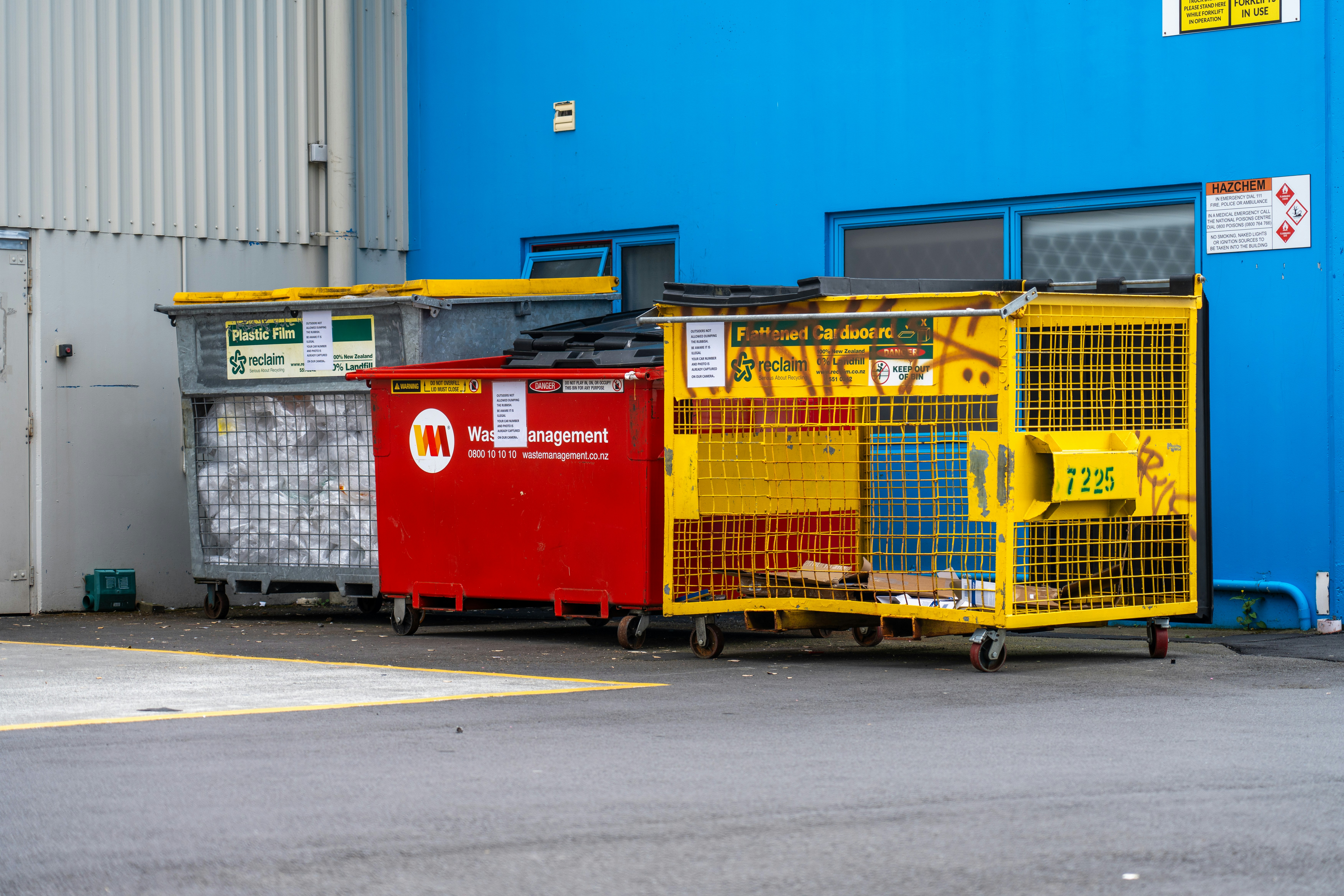 a couple of crates sitting next to a blue building