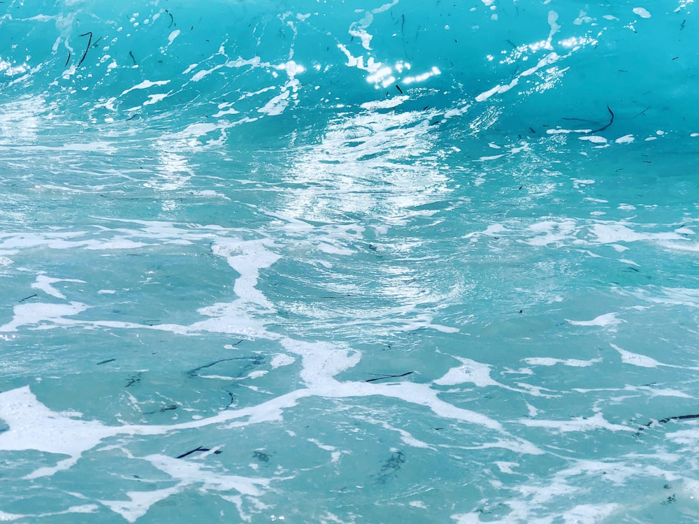 a person riding a surfboard on a wave in the ocean