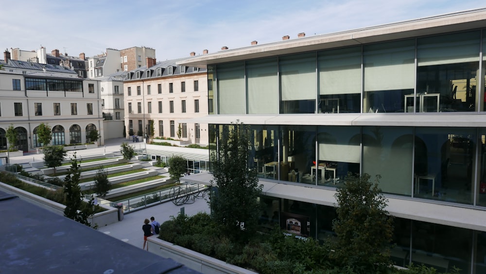 a building with a lot of windows and people walking around