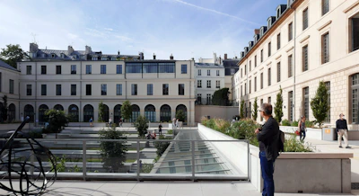 An inviting courtyard within a mixed-use project, featuring greenery and seating areas.