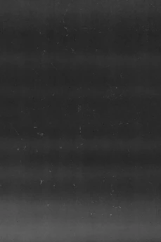 A gritty, dark concrete wall textured with subtle film grain and faint empire gold scratches.