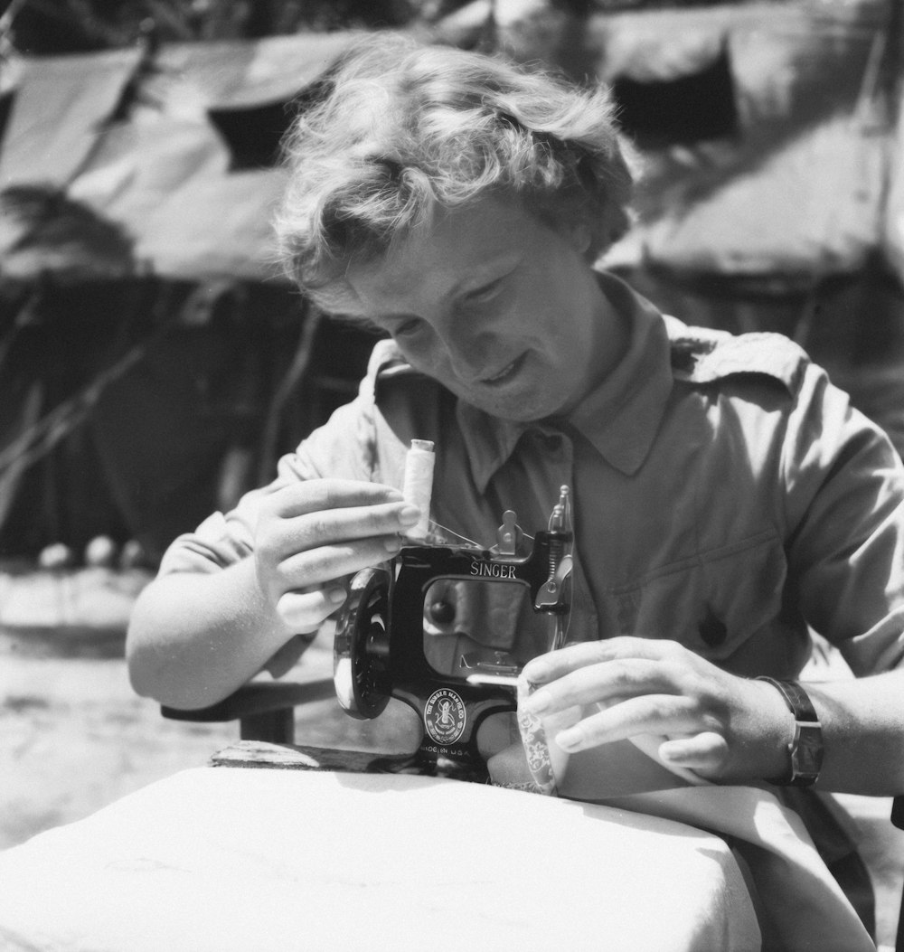 a black and white photo of a man holding a camera