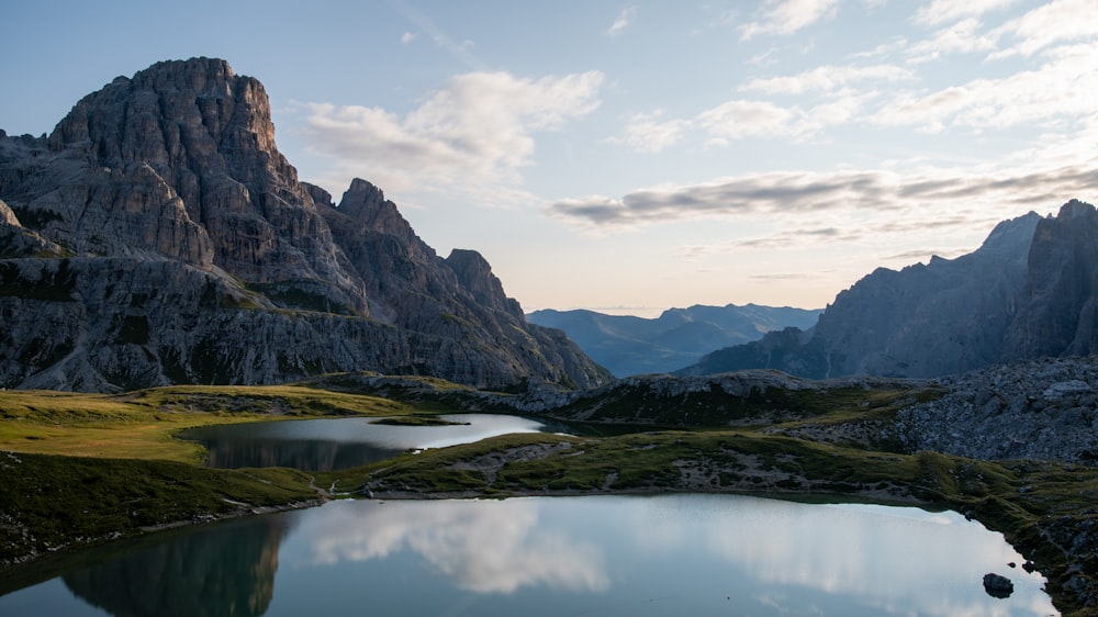 a mountain range with a lake in the foreground