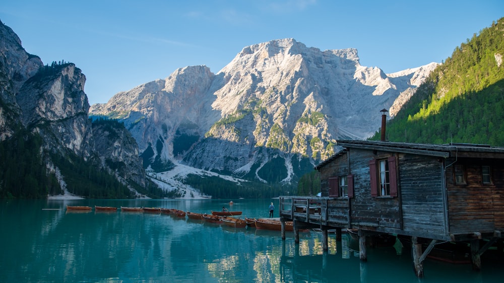 a wooden dock sitting next to a mountain lake