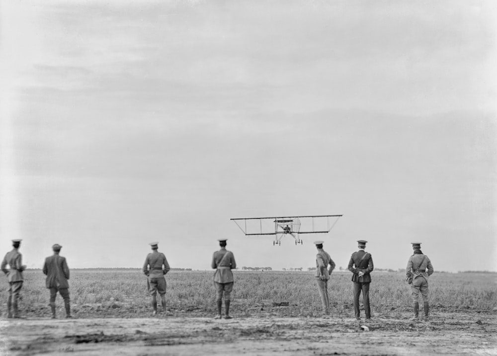 a group of men standing next to each other in a field