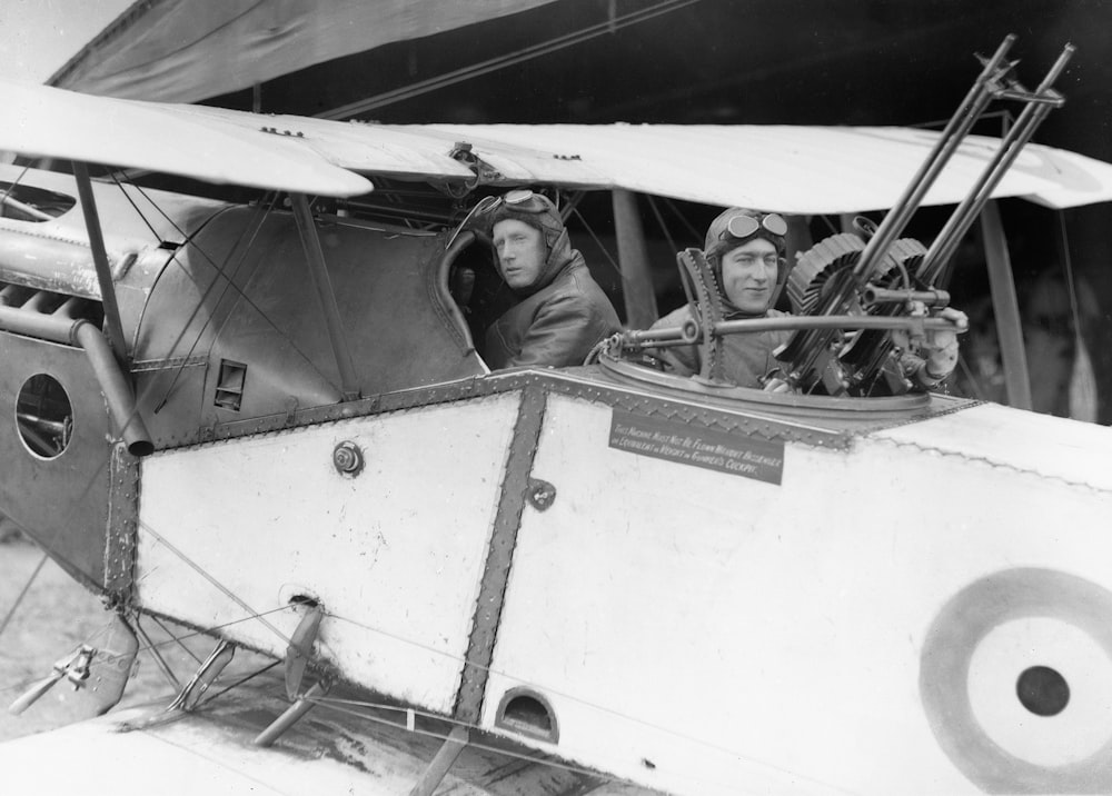 a black and white photo of people in an airplane