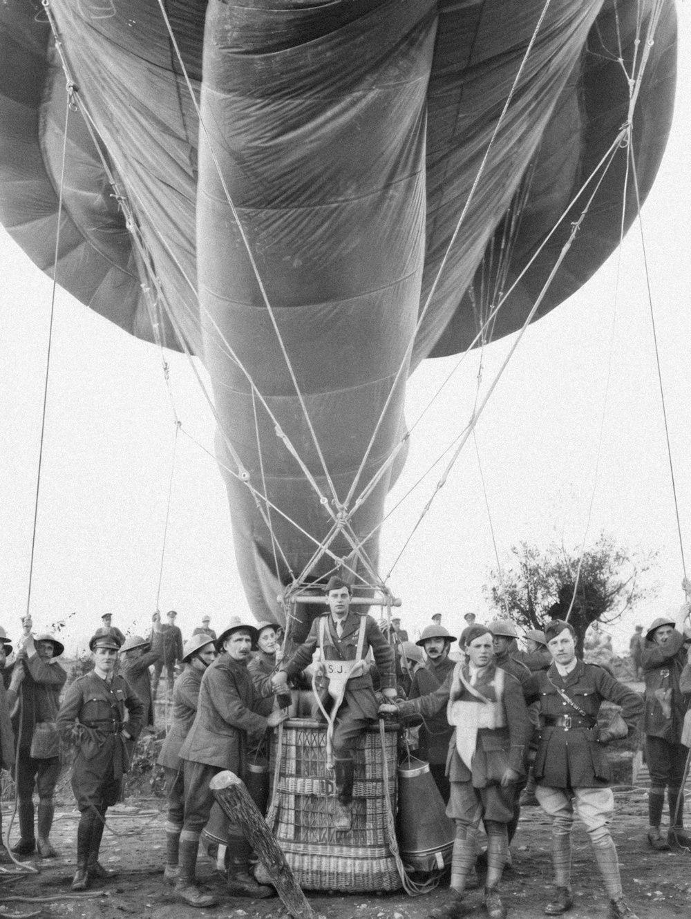 a group of people standing around a large balloon
