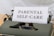 A close-up image of a vintage typewriter with a single sheet of paper inserted, displaying the words 'PARENTAL SELF-CARE' in bold letters. The typewriter has a classic design with visible keys and a dark green body.