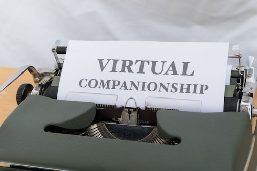 A typewriter holding a sheet of paper with the text 'VIRTUAL COMPANIONSHIP' typed on it. The scene captures the nostalgia of a traditional typing machine with a modern concept printed.