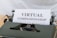 A typewriter holding a sheet of paper with the text 'VIRTUAL COMPANIONSHIP' typed on it. The scene captures the nostalgia of a traditional typing machine with a modern concept printed.