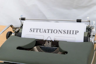 a close up of a typewriter with a paper that reads situation