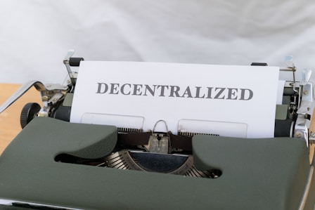 a typewriter with a paper that reads decentralized