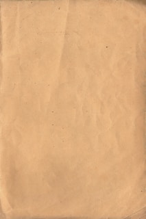 A softly lit vintage parchment background with delicate mottled textures.