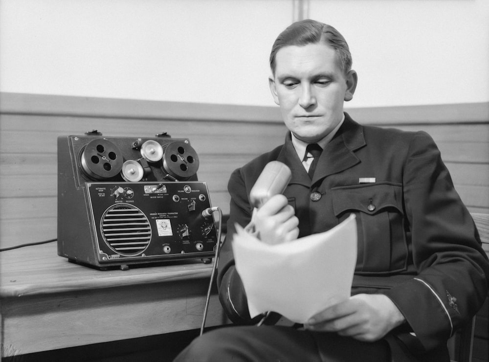 a black and white photo of a man in uniform