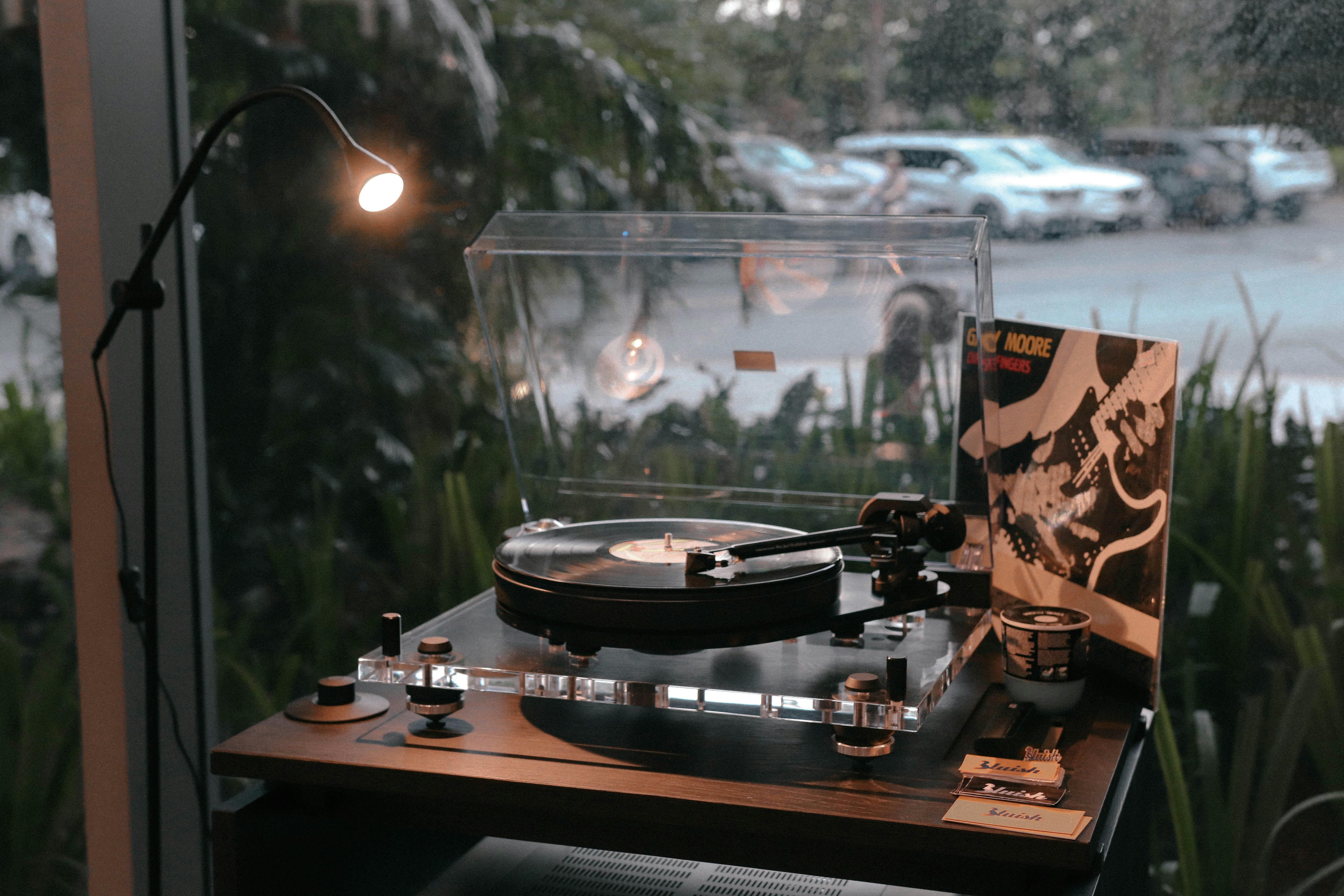 a record player sitting on top of a wooden table