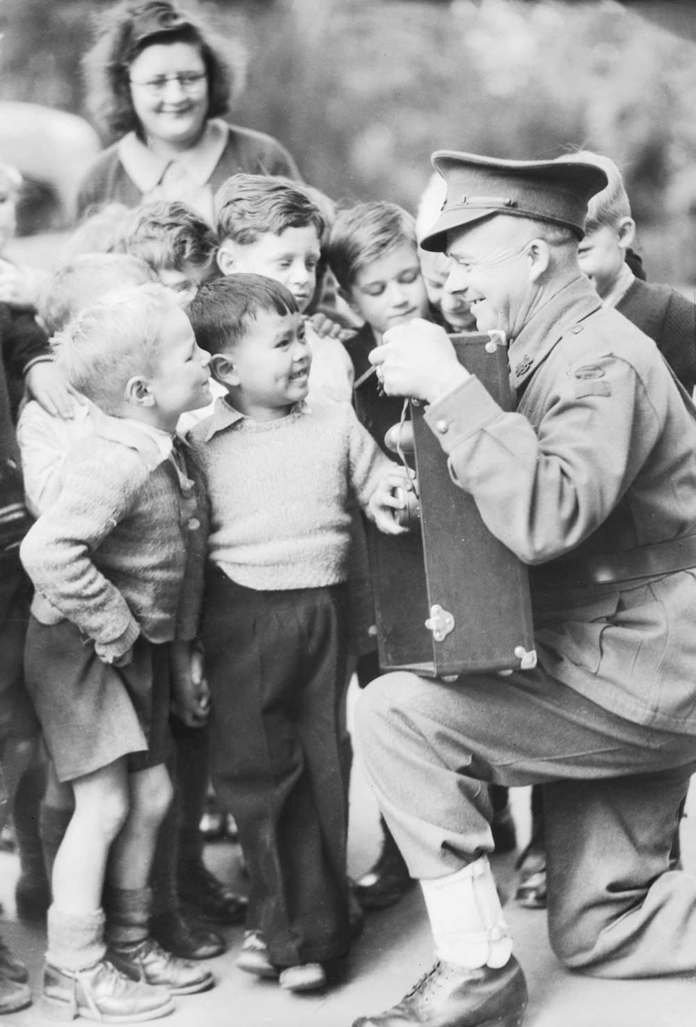 a black and white photo of a man in a military uniform with a group of