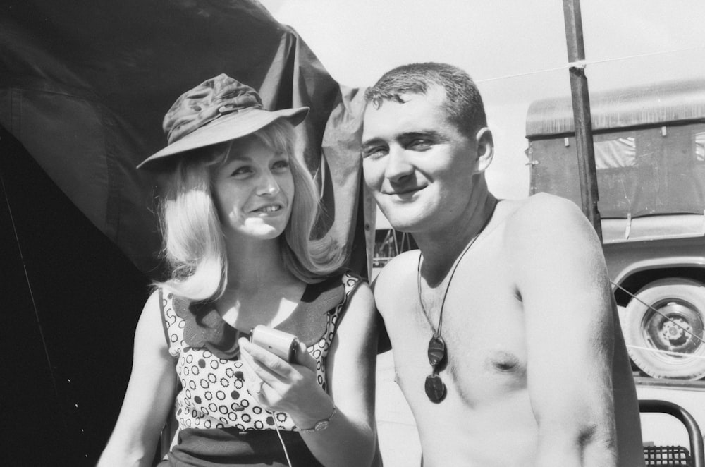 a man and a woman standing next to a truck