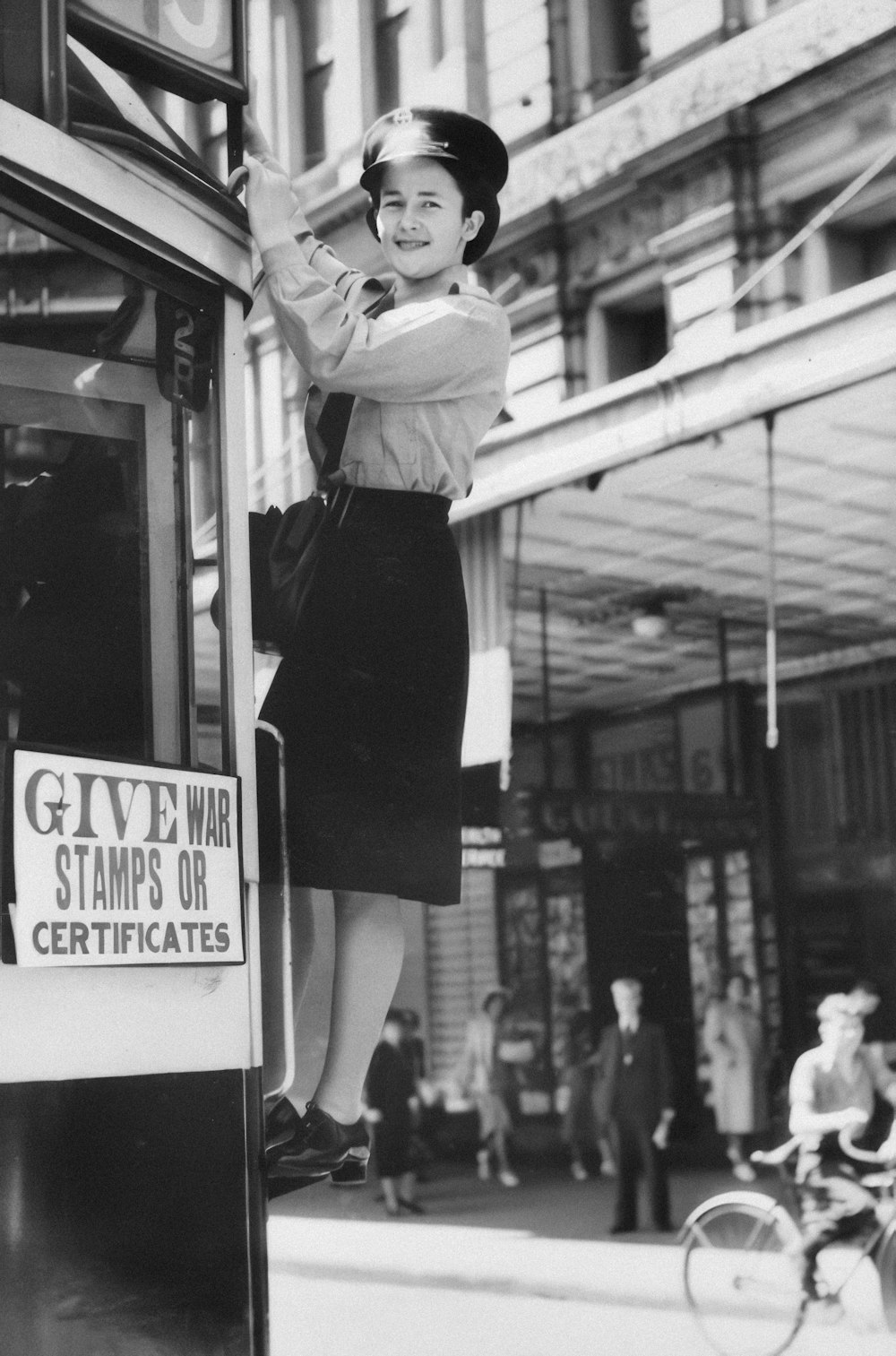 a woman standing on the side of a bus