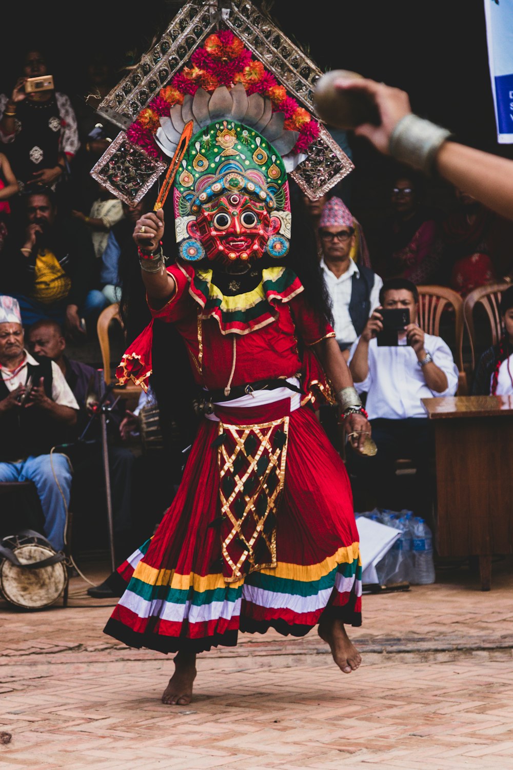 a person in a costume performing a dance in front of a crowd