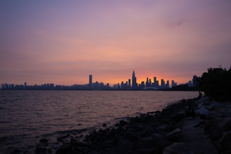 A serene view of Surabaya's skyline at sunset, symbolizing growth.