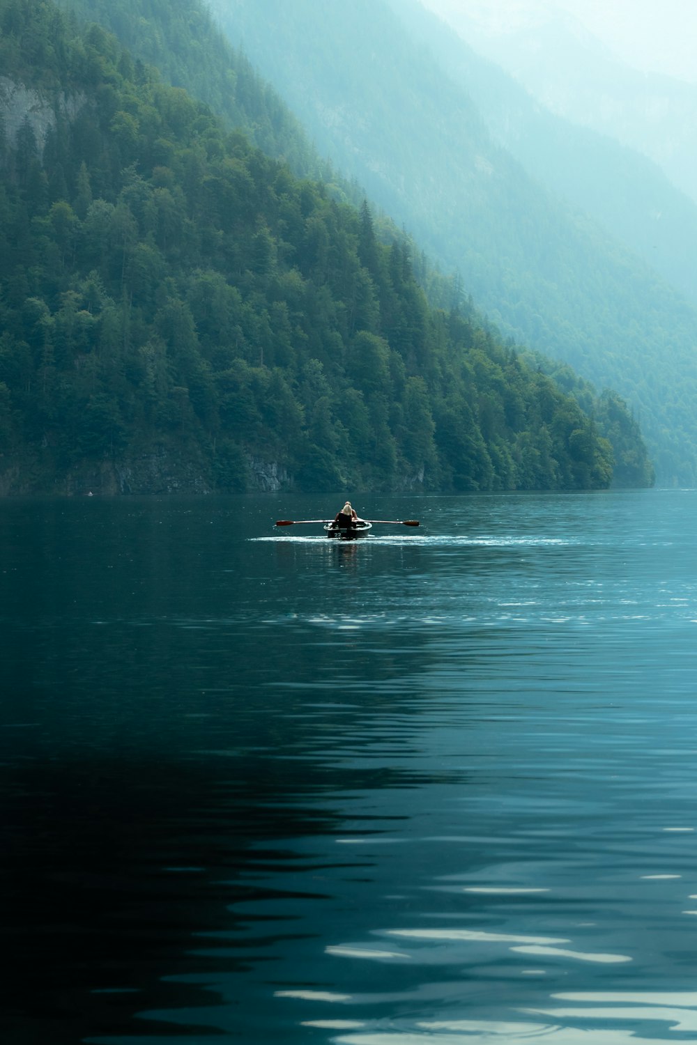 a person in a boat on a large body of water