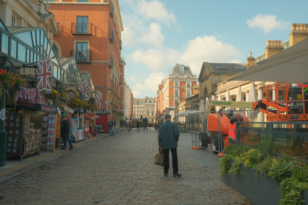 a man is walking down a brick street