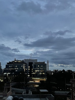 Sophisticated urban office view at dusk with deep shadows and illuminated cityscape.