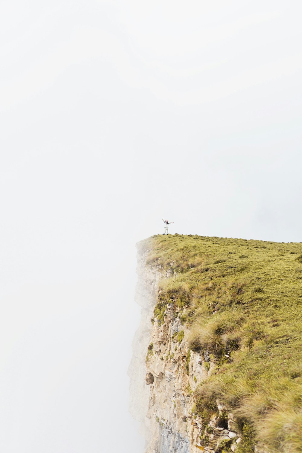 a person standing on the edge of a cliff