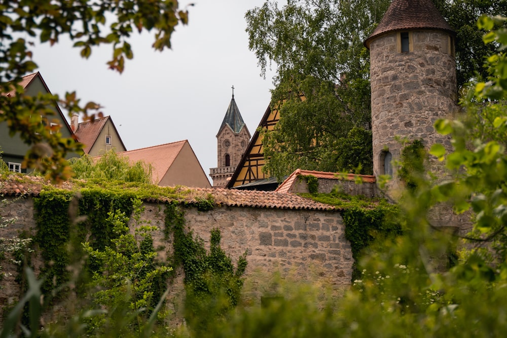 a stone wall with a clock tower in the background