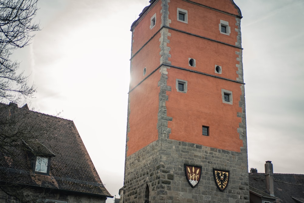 a tall brick tower with a clock on it's side