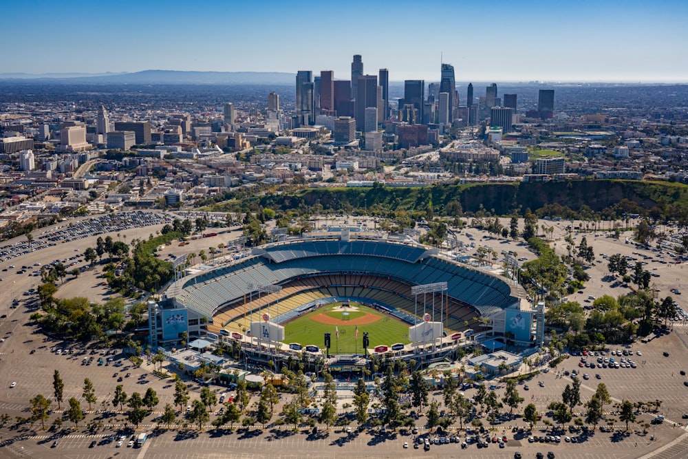 an aerial view of a baseball stadium with a city in the background