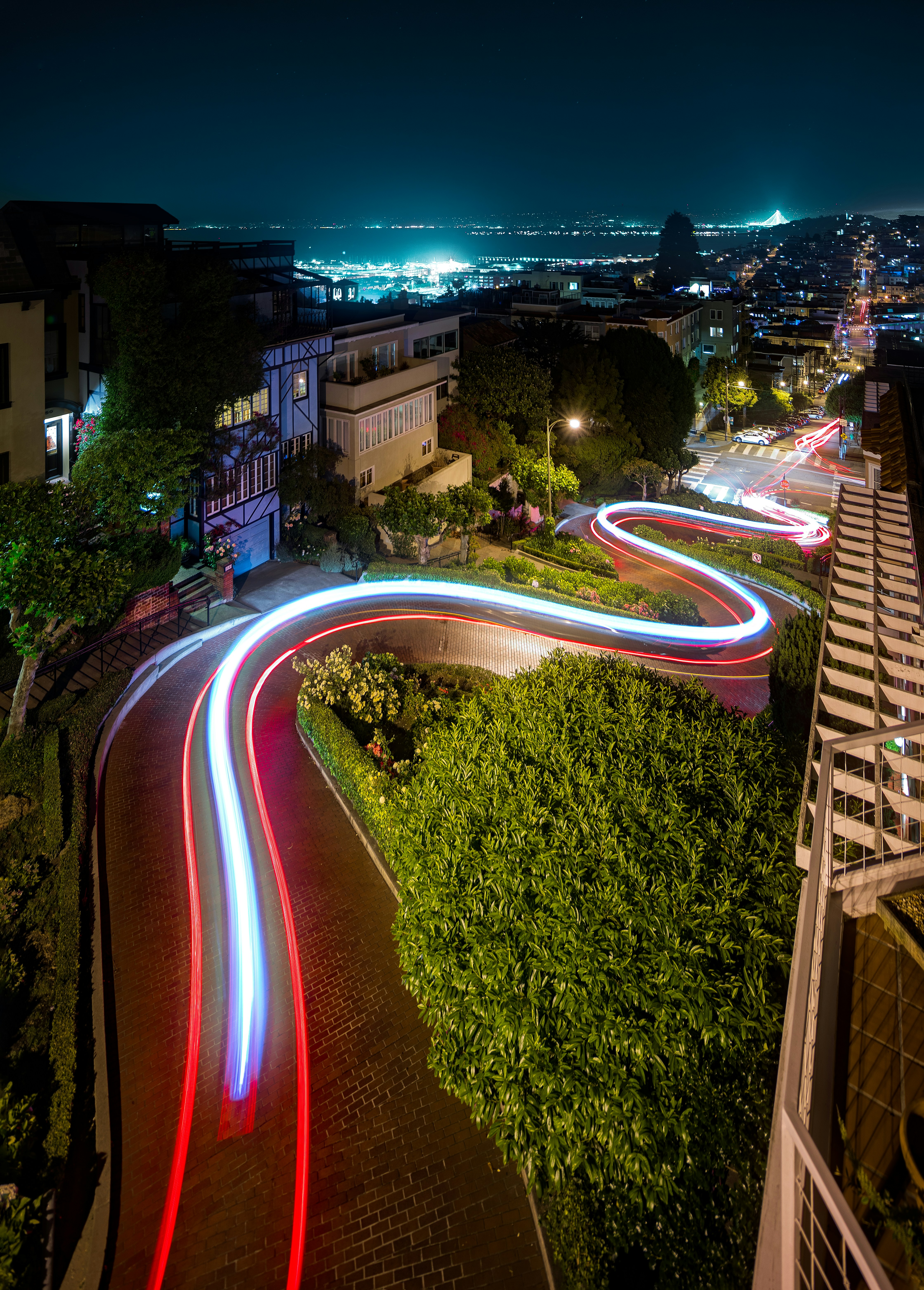 a long exposure photo of a city street at night