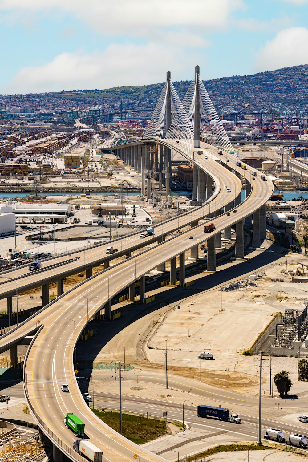 a freeway with multiple lanes and a bridge in the background