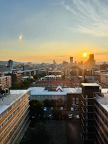 A cityscape showing residential and commercial buildings at sunset
