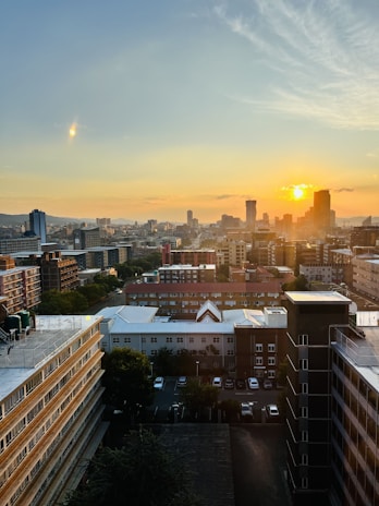 City skyline at sunset showcasing various residential and commercial properties.
