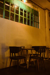 Cozy café interior with warm lighting and customers enjoying their drinks.