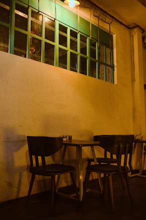 Cozy café interior with warm lighting and customers enjoying their drinks.