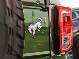 a green jeep with a white dog sticker on it