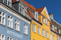 a row of colorful buildings with white windows